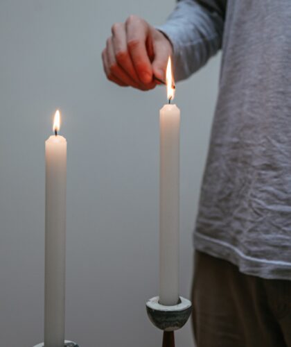 девушка зажигает свечи